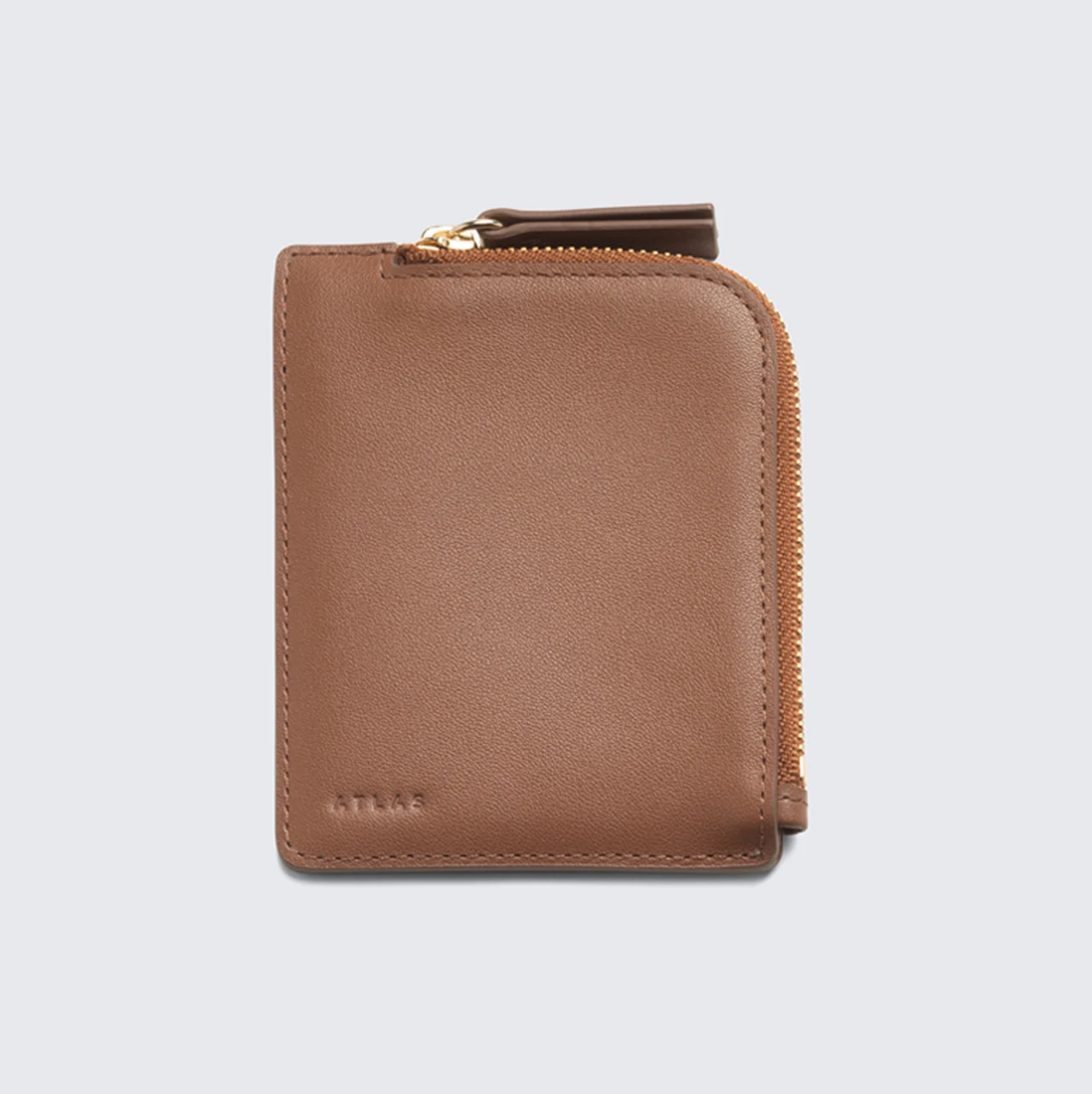 Brown leather zip wallet on a light background