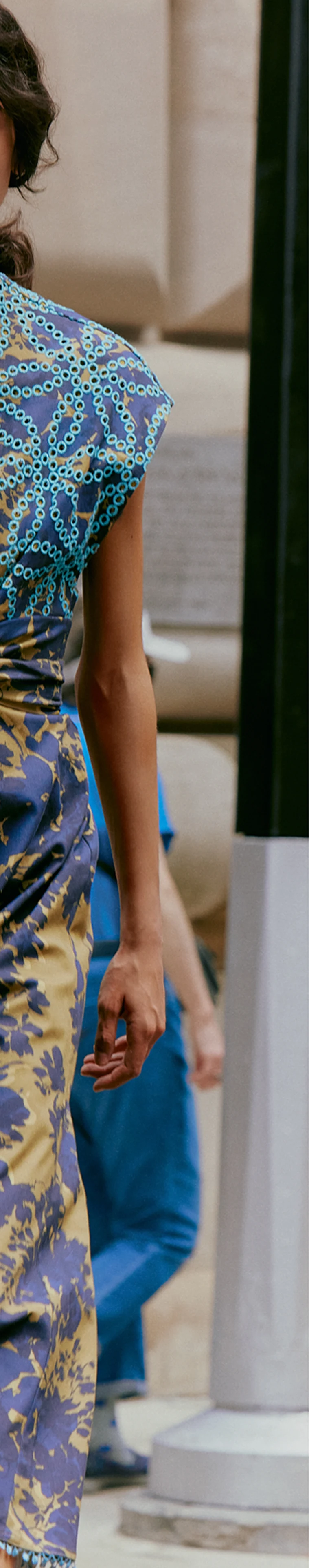 Before retouching: a person is visible behind the model