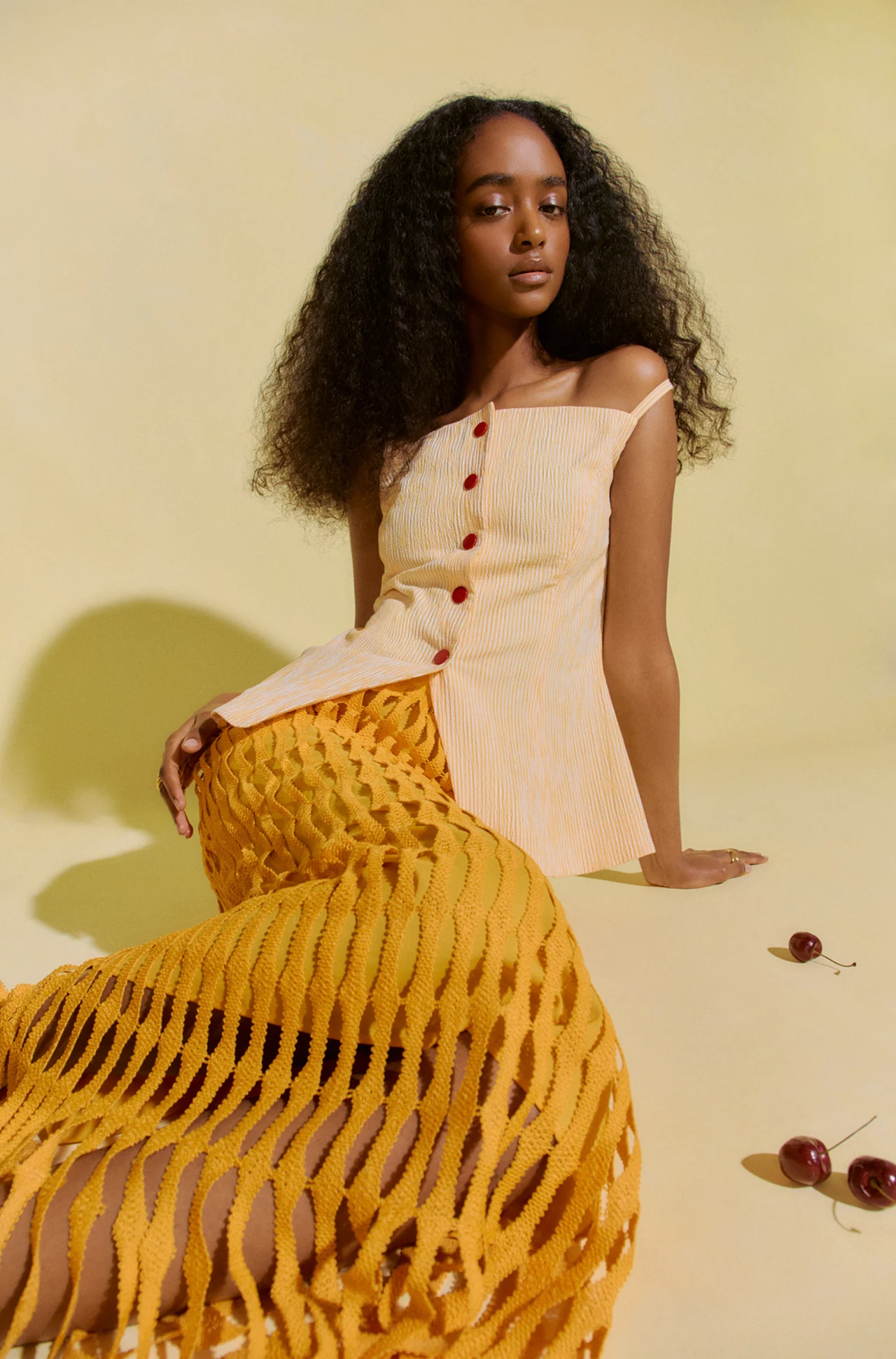 Model wearing a sculptural yellow skirt