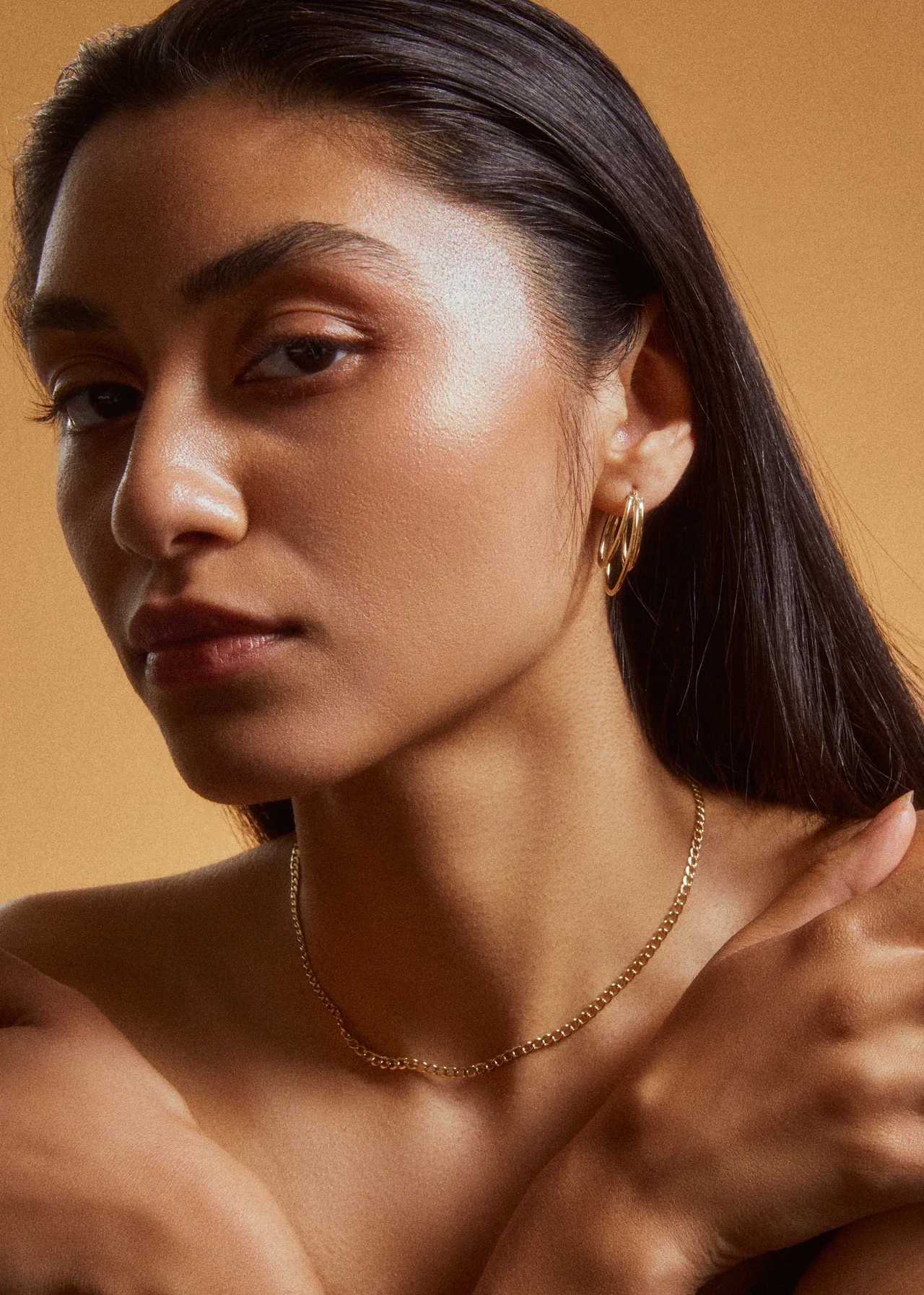 Warmly lit portrait with a fine gold necklace