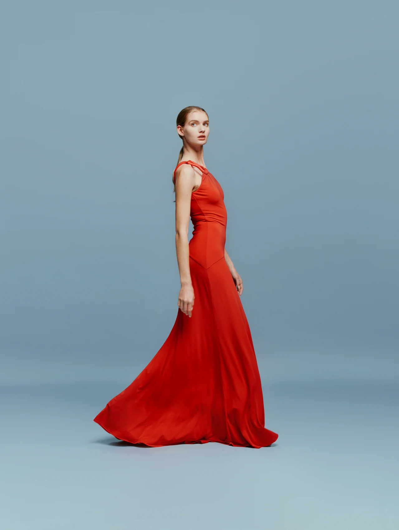 Full-length fashion portrait in a red gown